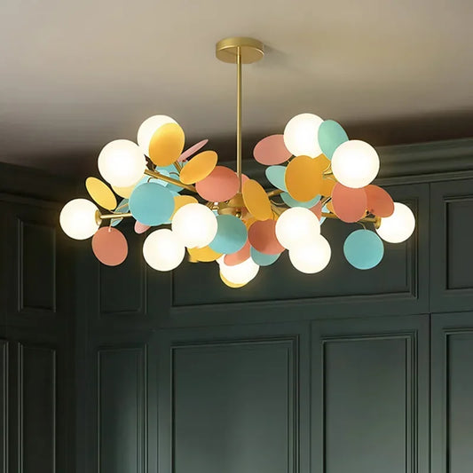 Close-up of the gold starburst chandelier frame with white globe lights.