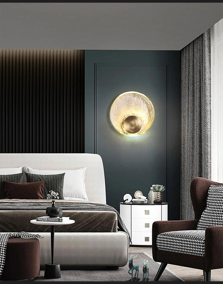 Modern bedroom with a bed, side table, and wall-mounted lamp.