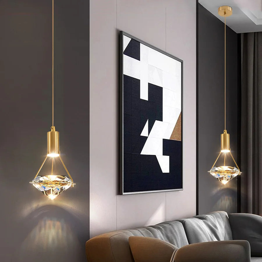 Modern interior with abstract art, gold pendant lights, and a gray sofa.
