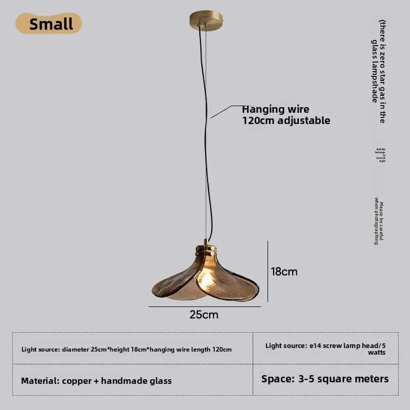 Gold pendant light with adjustable hanging wire on a gray background