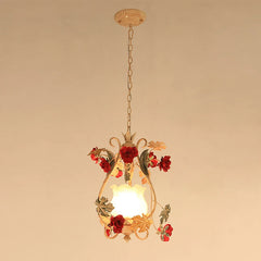 A single gold floral pendant light with red rose accents and a frosted glass shade, hanging from a chain against a plain background.