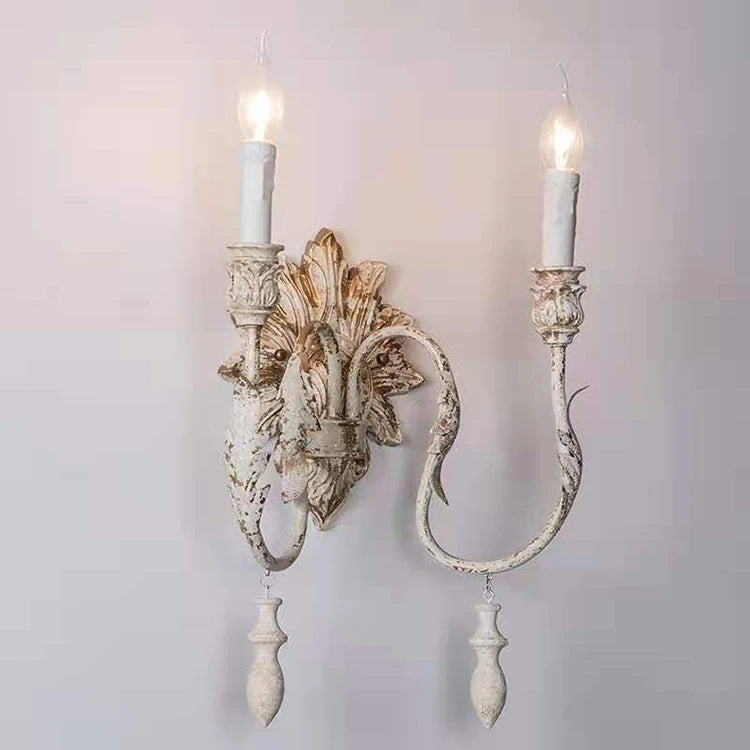 Decorative wall sconce with intricate design on a plain background