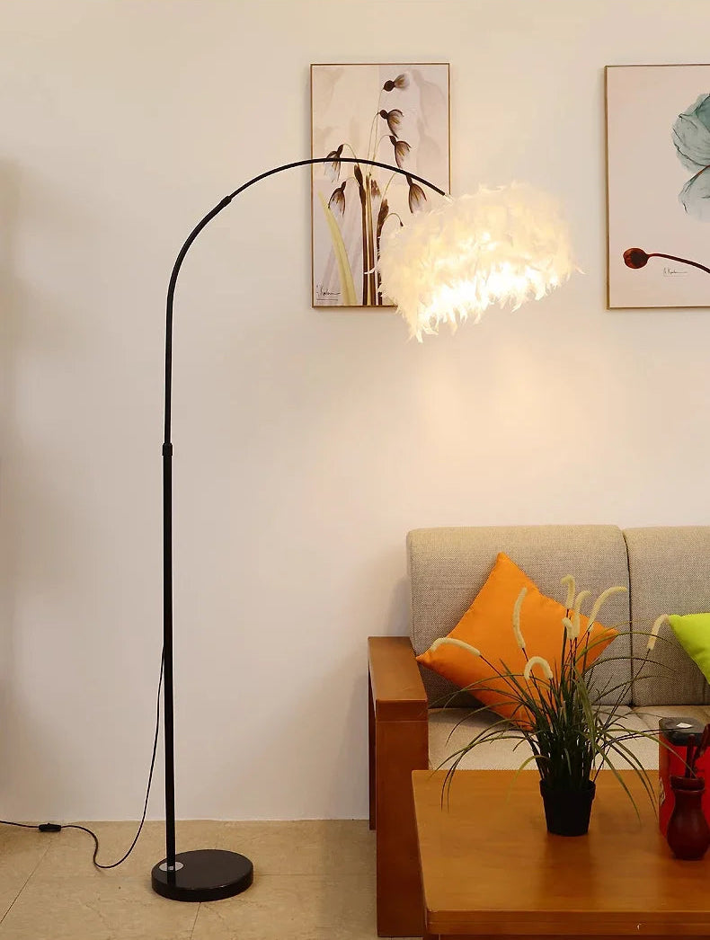 Modern floor lamp in a living room setting with a sofa and decorative items.