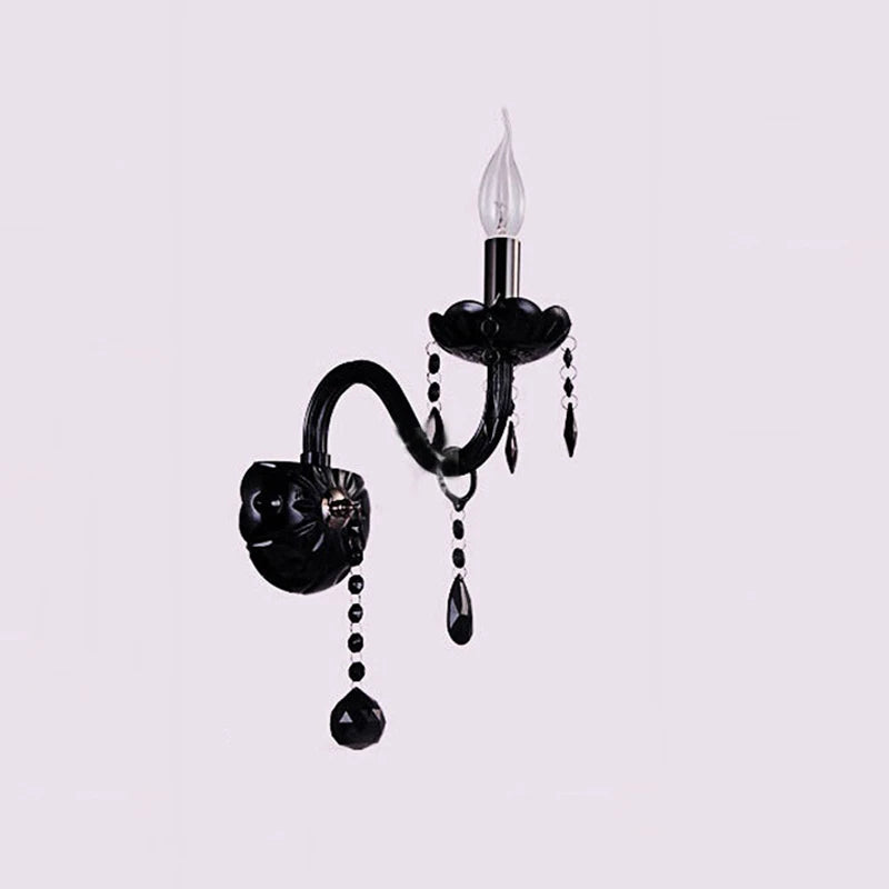 Black wall sconce with fabric shade and cascading crystal droplets.