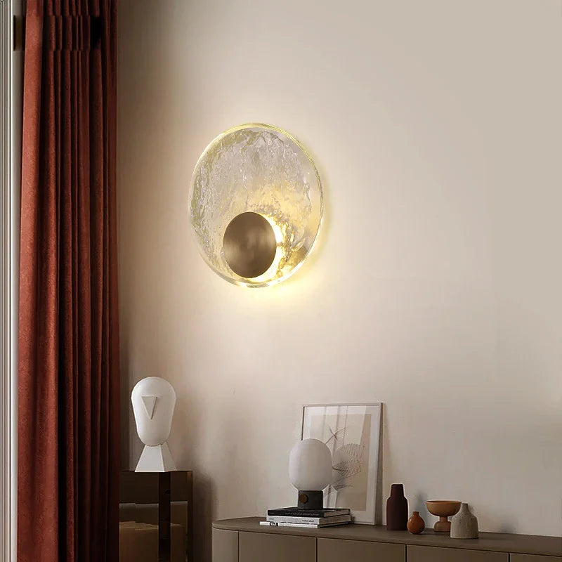 Modern wall lamp with a decorative design on a neutral wall.
