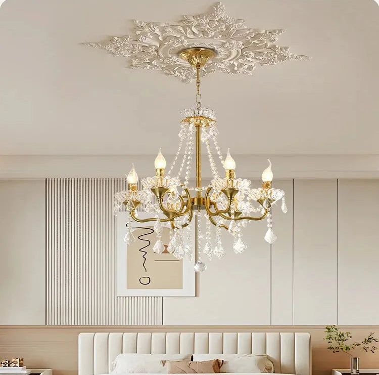 Luxurious bedroom with a chandelier, bed, and decorative elements.