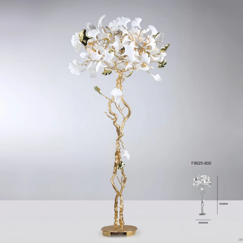 Decorative floor lamp with white floral design and gold base on a gray background