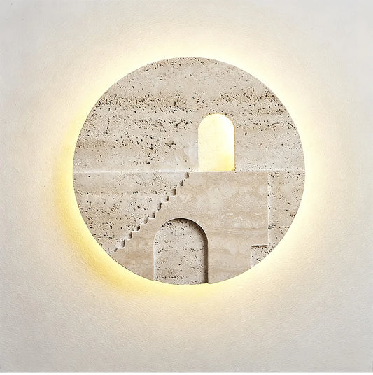 Round natural stone wall sconce with a carved staircase and archway illuminated by warm LED light from behind.