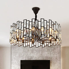 A close-up view of a circular chandelier featuring a black metal frame and numerous clear rectangular crystals.