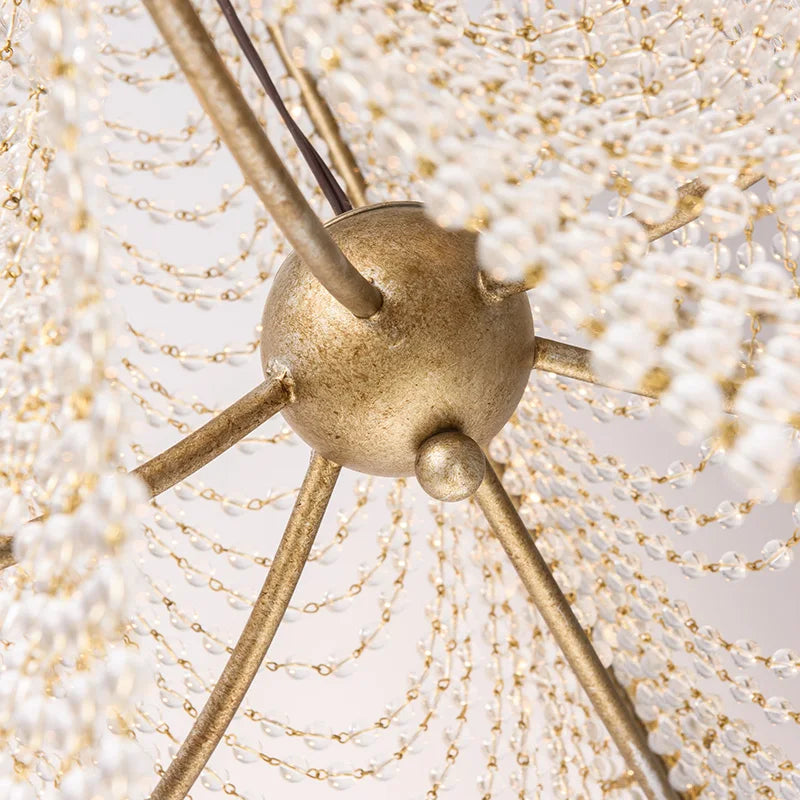Detail shot of the intricate crystal beadwork and silver metal frame of a wall sconce.