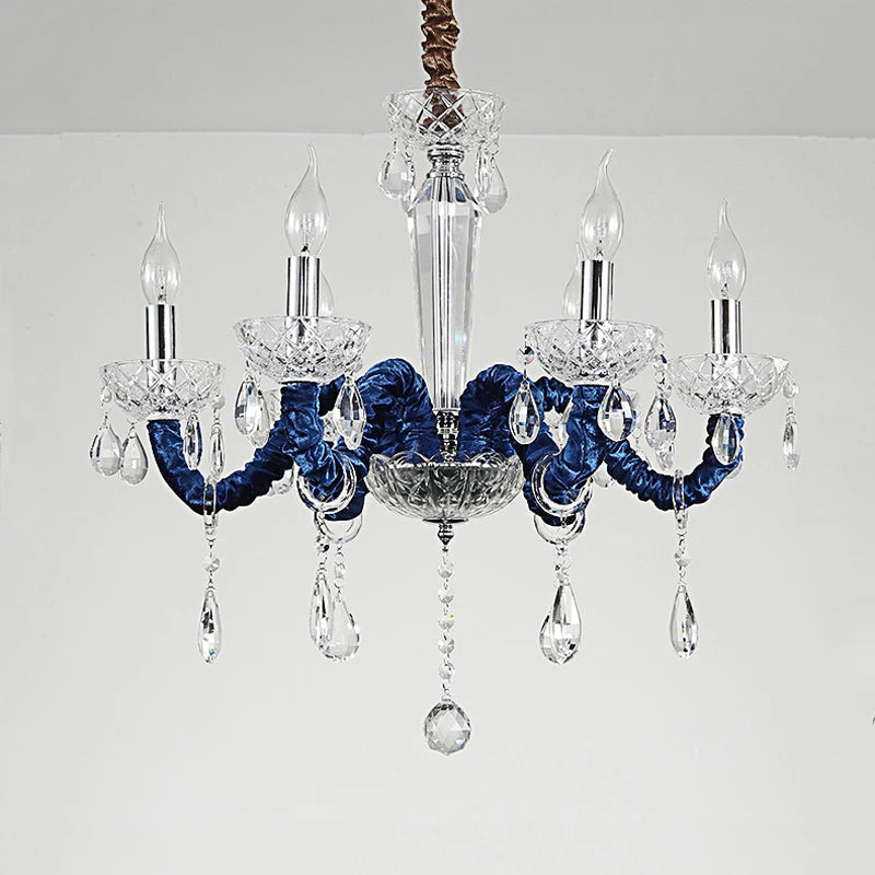 Close-up view of a 6-head chandelier showcasing its chrome arms, clear crystal pendants, and candle-style light sockets.