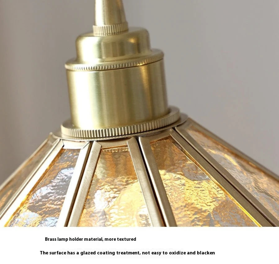 Brass lamp holder with textured surface on a neutral background