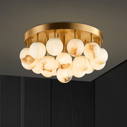 Close-up of a gold ceiling light fixture with several marble-effect glass spheres.