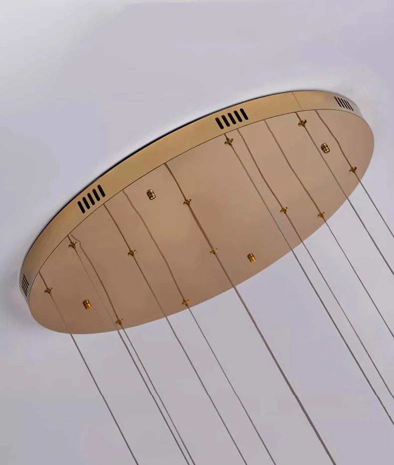 Ceiling light fixture with beige shade and gold accents on a white ceiling.