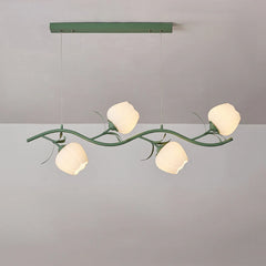 Close-up view of a green floral chandelier with five white tulip-shaped shades on a green branch-like fixture.