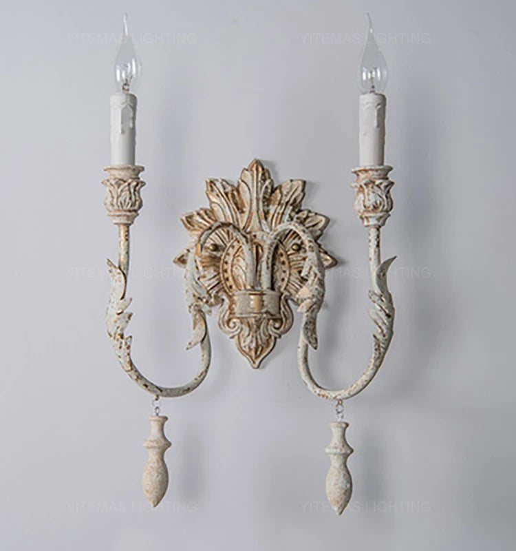 Decorative wall sconce with intricate design on a plain background