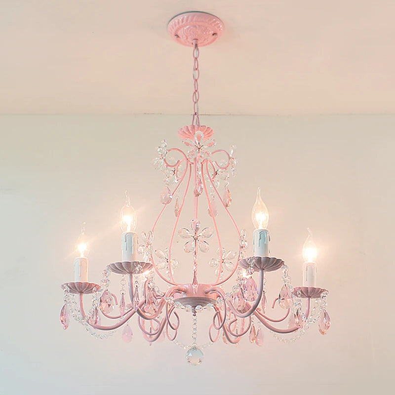 Pink semi-flush mount chandelier with crystal flower accents and hanging crystal droplets, illuminated.