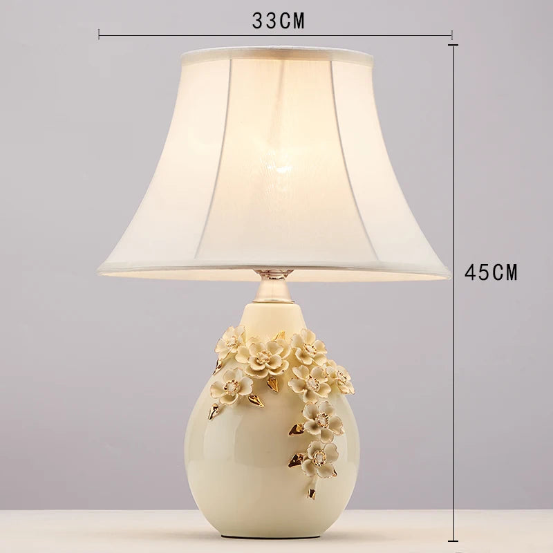 Decorative table lamp with floral design on a gray background
