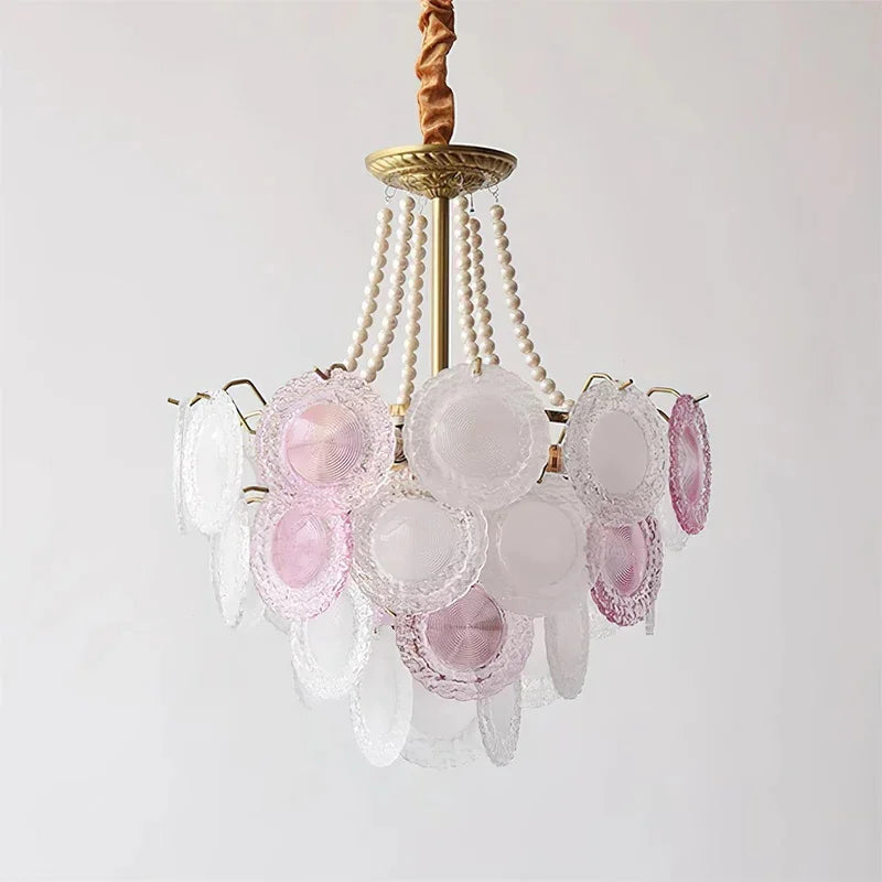 Chandelier with pink and clear glass shades on a white background