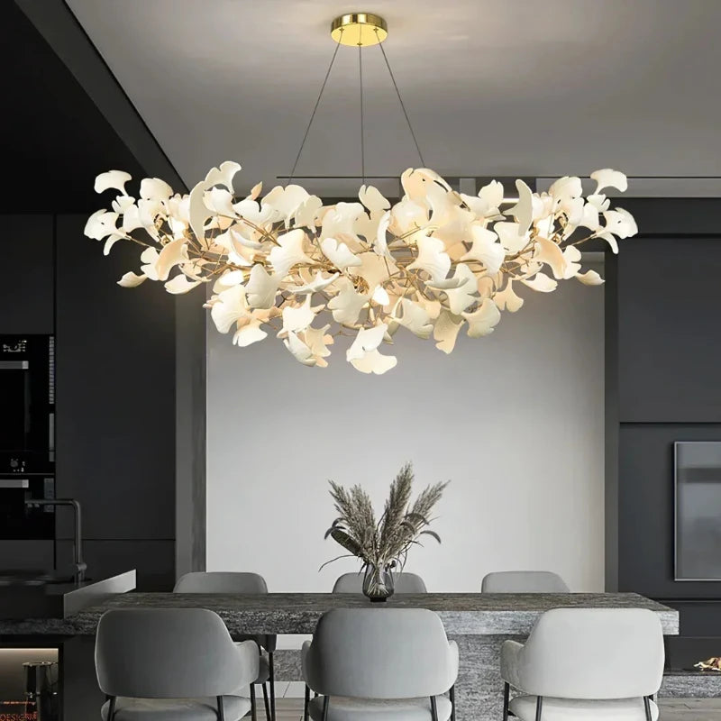 Gold ginkgo leaf cluster pendant light over a dining table