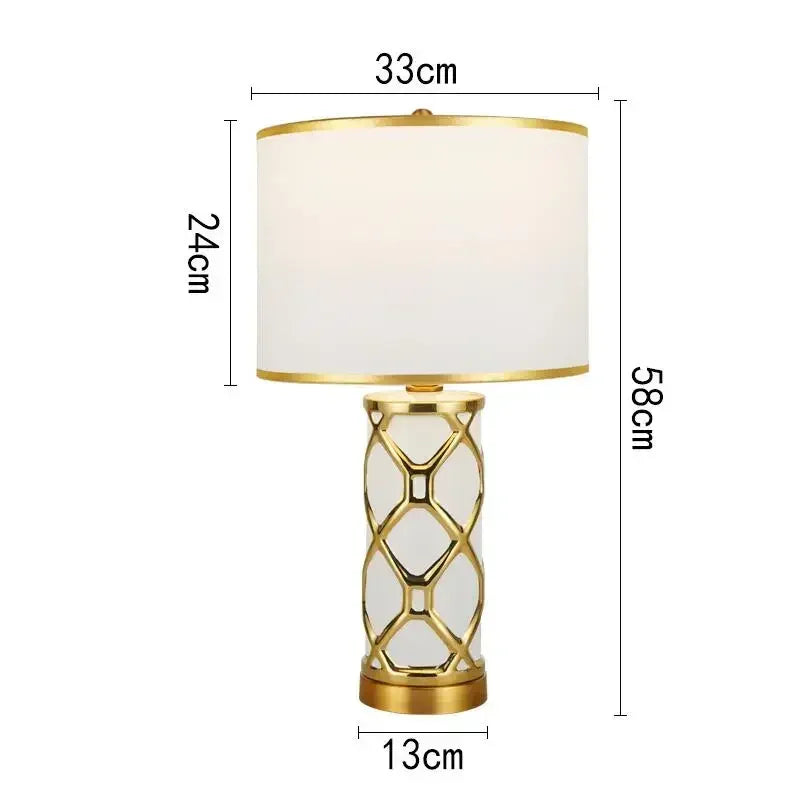 Table lamp with gold base and white shade, shown with dimensions on a white background
