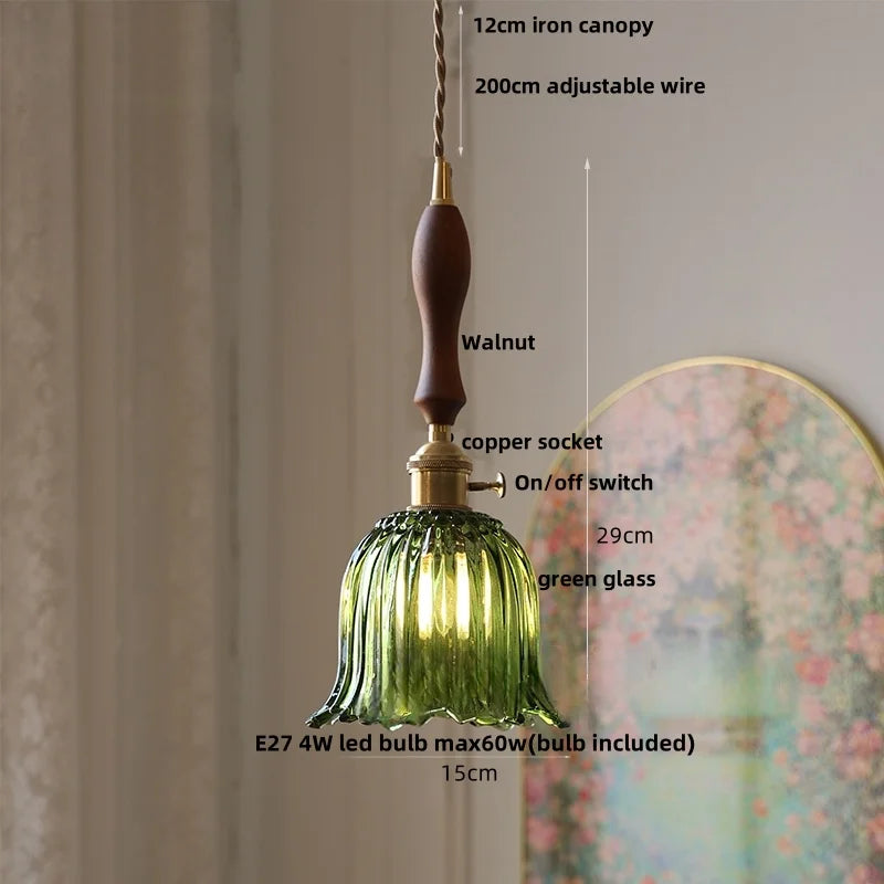 Green glass pendant light with measurements and features on a neutral background