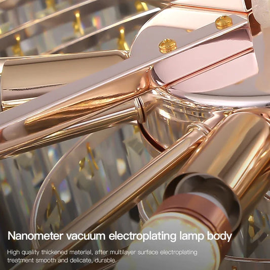 Close-up view of the internal hardware of a chandelier, showing a rose gold and silver-toned metal finish with visible screws and attachment points.