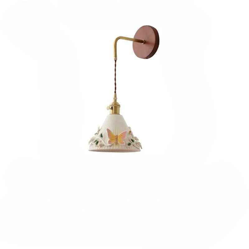 Wall-mounted lamp with decorative shade on a white background