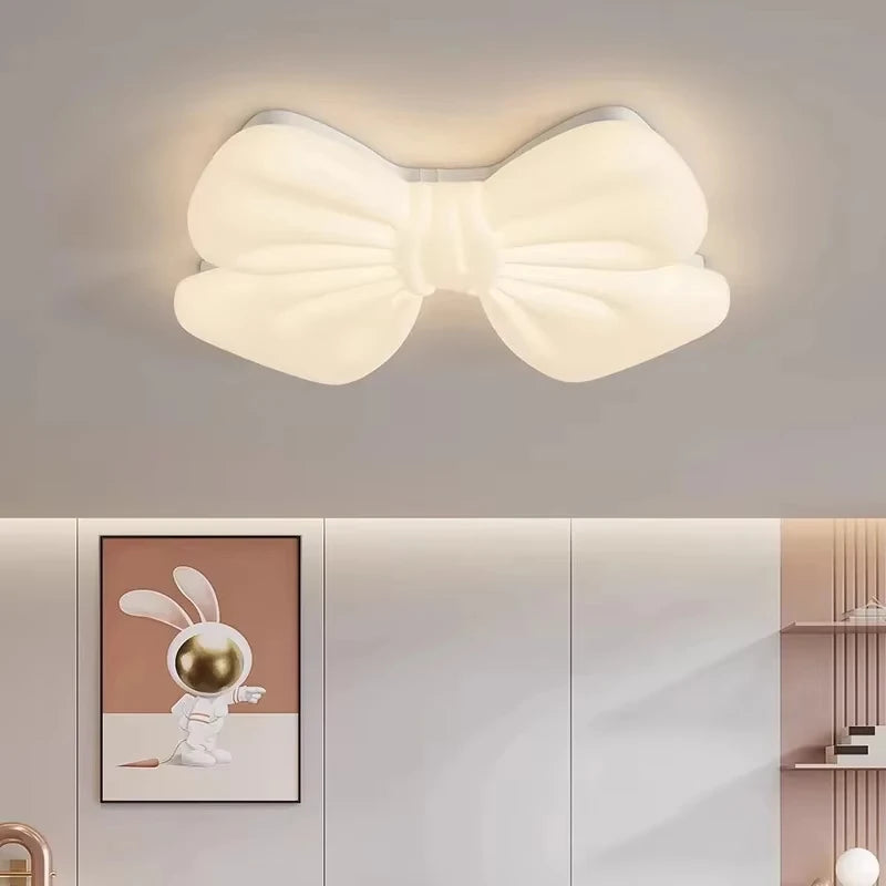 White butterfly knot flush mount ceiling light above a bed
