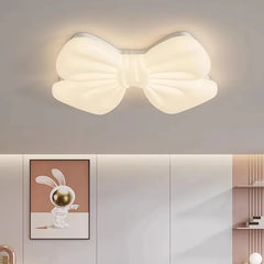 White butterfly knot flush mount ceiling light above a bed