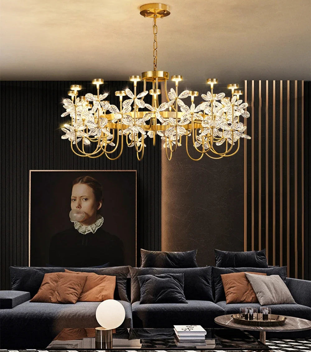 Luxurious living room with a chandelier, sofa, and decorative items.