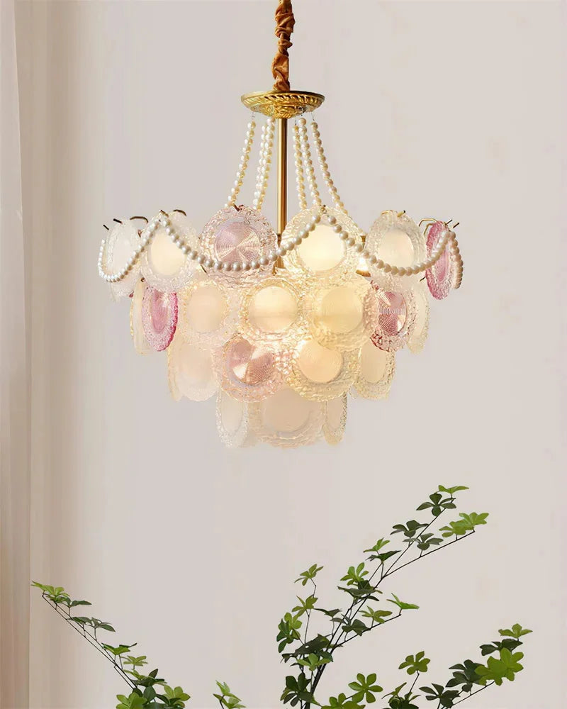 Decorative chandelier with pink and white floral elements on a light background