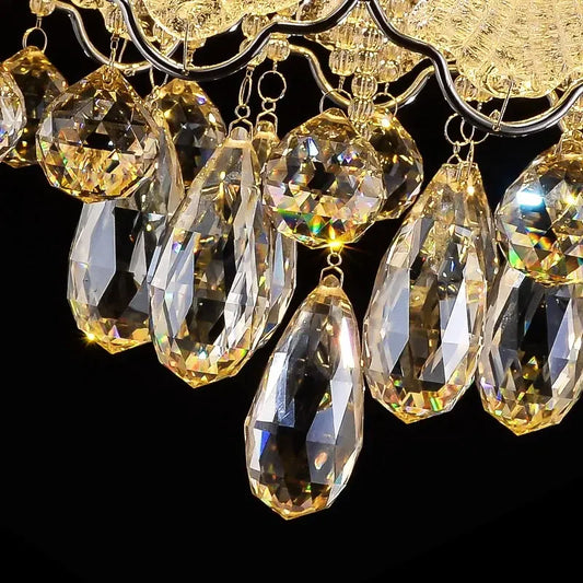 Close-up view of the cascading crystal teardrops and faceted spheres of the chrome chandelier, showing intricate detail and light refraction.