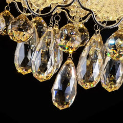 Close-up view of the cascading crystal teardrops and faceted spheres of the chrome chandelier, showing intricate detail and light refraction.