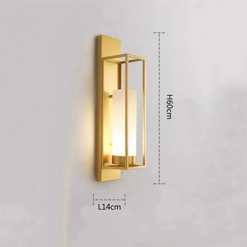 Gold wall-mounted light fixture with dimensions on a gray background