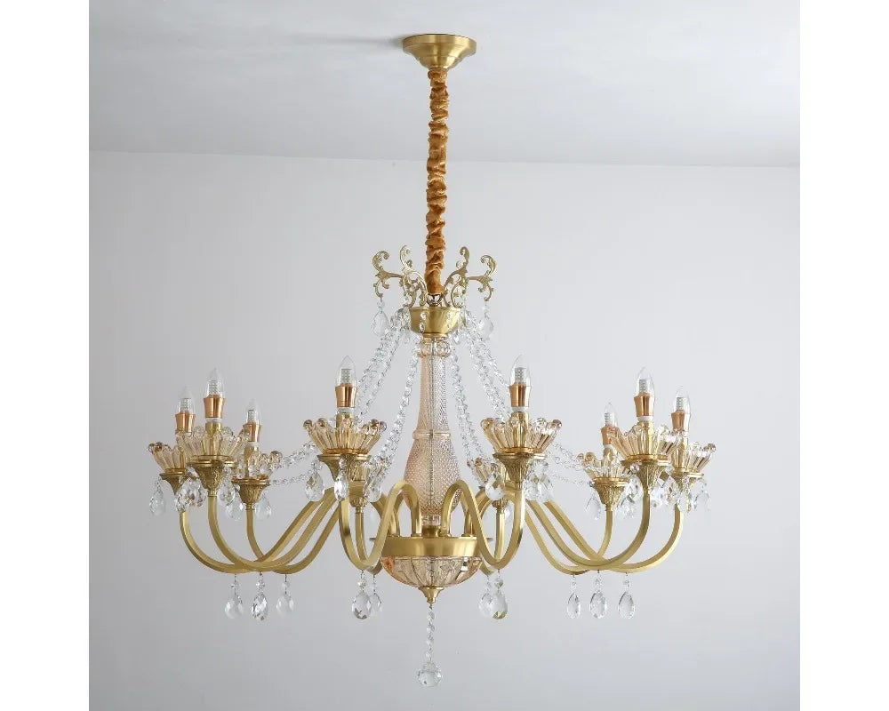 The gold chandelier viewed from below, showing the candelabra-style bulbs and central crystal pendant.