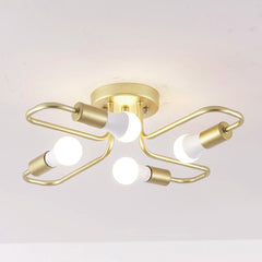 Gold metal starburst semi-flush ceiling light fixture with four exposed LED bulbs