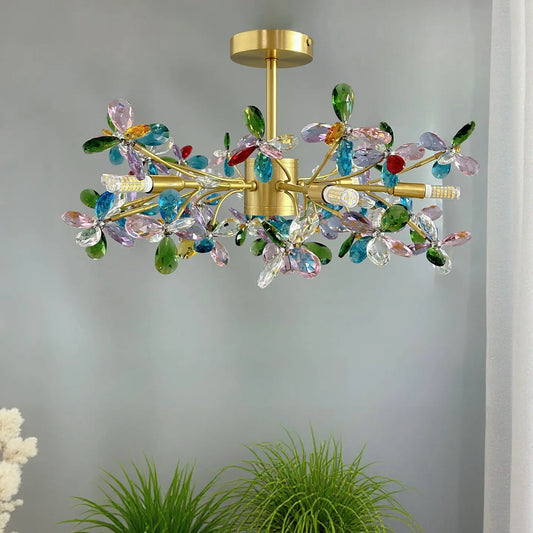 Close-up view of the multi-colored crystal flower details and gold frame of the chandelier.