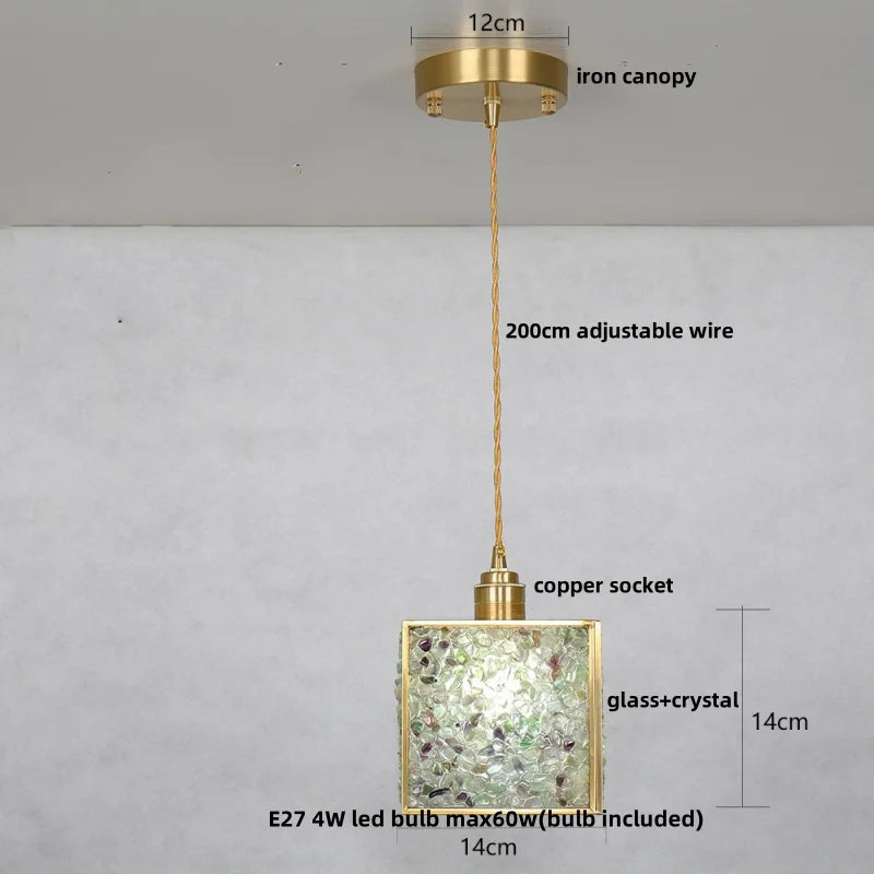 Gold pendant light with labeled parts on a gray background