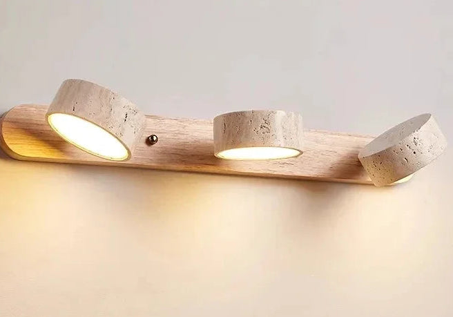 Wooden wall light fixture with two illuminated bulbs on a neutral background