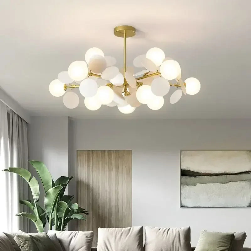 A bright living room with a gold starburst chandelier illuminating the space.