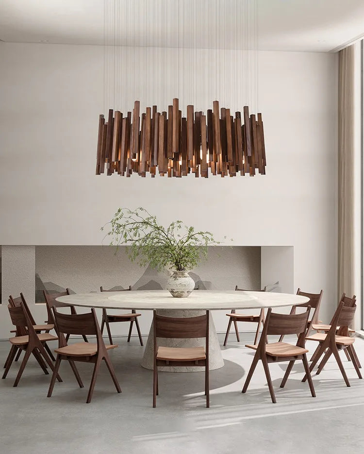 Modern dining room with a wooden pendant light, round table, and chairs.