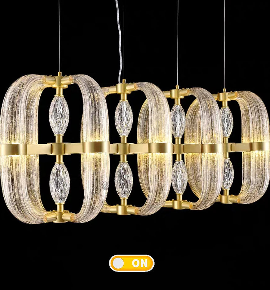 Gold and glass chandelier with 'ON' indicator on a black background