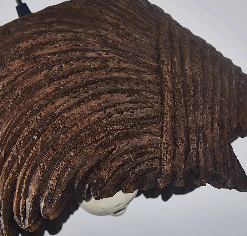 Close-up of a textured brown winged object on a white background