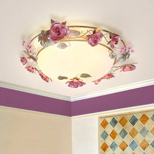 Pink rose bud floral design semi-flush ceiling light installed in a room corner with purple accent wall and patterned tiles