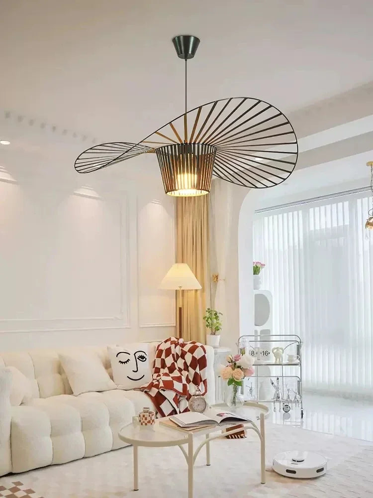 Modern living room with a stylish chandelier, white sofa, and decorative elements.
