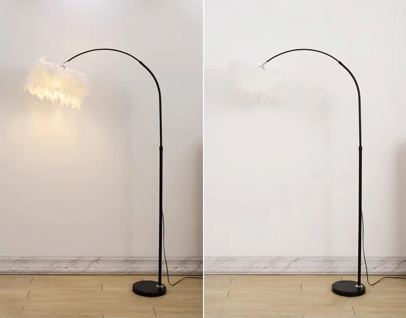 Black arch floor lamp on a wooden floor with a white wall background