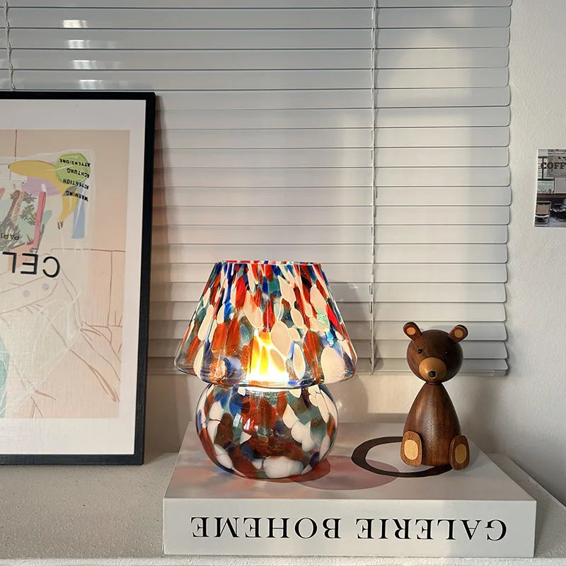 Colorful lamp with a wooden bear figure on a shelf in a room setting.