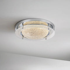 Detail shot of the textured frosted glass on a chrome flush mount ceiling light fixture.