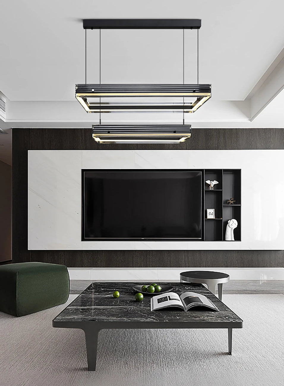 Modern living room with a television, coffee table, and decorative items.